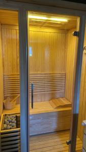 a sauna with a wooden floor and a wooden door at Vila Tom & Jerry in Raška