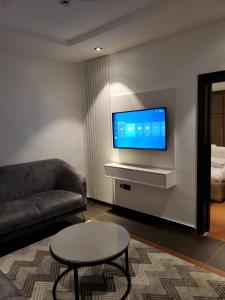 a living room with a couch and a tv at Hotel Thirty Five in Lagos