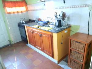 a small kitchen with a sink and a stove at El Marino in Merlo