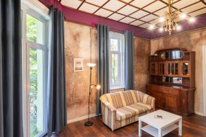 a living room with a chair and a table at The Green Bar House in Sofia
