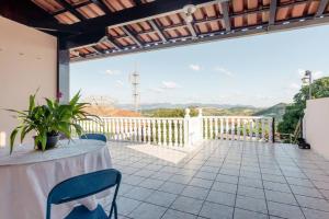 a table and chairs on a patio with a view at Suite Vista Panorâmica in Betim