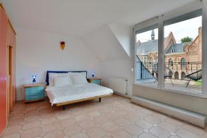 a bedroom with a bed and a large window at 5,Batthyani Square, Buda, Panorama, Parliament in Budapest