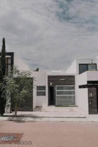 a white house with its door open on a street at Spectacular House w/ Pool & Amazing Location in Trojes de Alonso