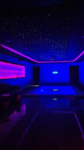 a living room with blue and purple lights at شاليهات يارا القيروان in Riyadh