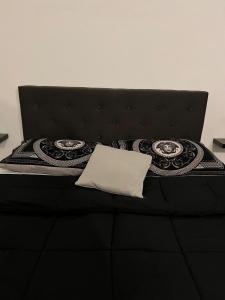 a black bed with a black headboard and a white pillow at Stazione centrale La Spezia 5 Terre - Luxury house in La Spezia