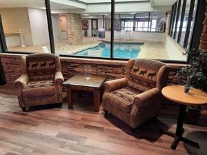 a living room with two chairs and a swimming pool at Silverado II in Winter Park