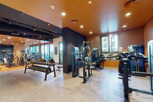 a gym with treadmills and machines in a room at La Voile Building 1 - Locations in Dubai