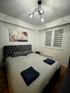 a bedroom with a large bed with blue pillows on it at Short stay accommodation in Dolno Nerezi