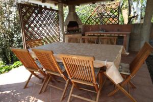 stół i krzesła na patio z kominkiem w obiekcie Apartments with Terrace w Bašce