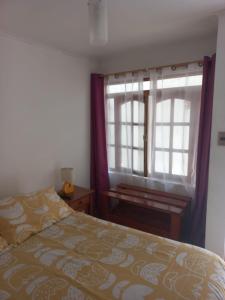 a bedroom with a bed and a window at Rutero in La Serena