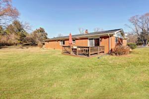 a small house with a porch and a yard at Beautiful 3 BR/2 Bath Very Close to IU & Downtown in Bloomington