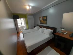 Cama ou camas em um quarto em Hotel Dom Joao IV