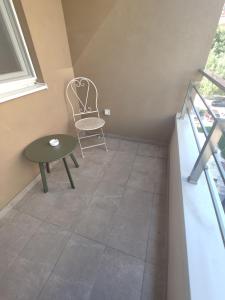 uma cadeira e uma mesa num quarto em Cozy Urban Apartment in Skopje! em Skopje