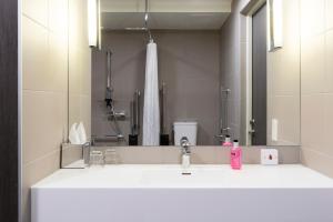 a bathroom with a sink and a mirror at Moxy Aberdeen Airport in Dyce