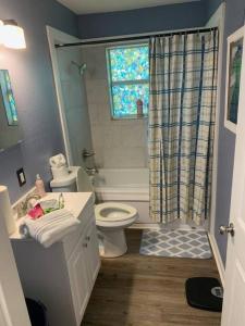 a bathroom with a toilet and a sink and a shower at Lovely 4 BR Home Near Fort Johnson-14 Minute Drive in Leesville