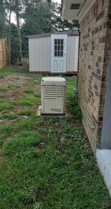 an appliance sitting in the grass next to a house at Lovely 4 BR Home Near Fort Johnson-14 Minute Drive in Leesville