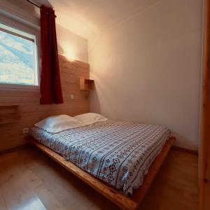 a bedroom with a bed in a room with a window at Le NID D'ARAN in Luchon +7 photos