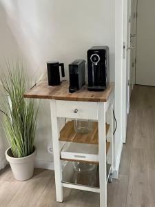 a white table with a coffee maker on top of it at Chalet goudmeer LUXURY AIRCO WIFI 3 bedrooms 2 bathrooms in Oosterwolde