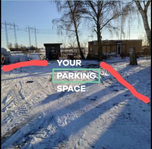 a sign that says your parking space in the snow at Lyckans Lodge in Dösjebro