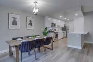 a kitchen and dining room with a table and chairs at Exclusive Airport Proximity: Condo at Crystal City in Arlington