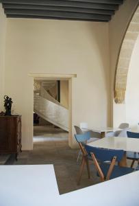 a room with a table and chairs and a staircase at Lokàl Boutique Hotel in Larnaca