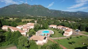 an aerial view of a resort with a swimming pool at Les villas de Mélody in Santa-Maria-Poggio