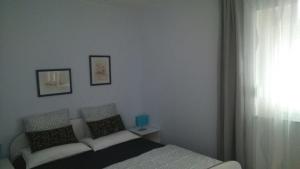 a bedroom with a bed and a window at Apartment Lena in Čižići