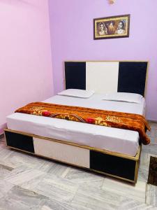 two twin beds in a room with at Hari Ganga Near By Bus And Railway Station in Haridwār