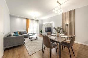 a living room with a table and a couch at Luxurios Modern Apartment Marina Bay in Durrës