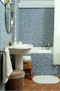 a blue tiled bathroom with a sink and a tub at La Ginesta Rural, cerca de Sitges in Canyelles +14 photos