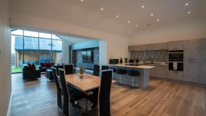 a kitchen and living room with a table and chairs at Northumberland Luxury Stays - The Shearling in West Chevington