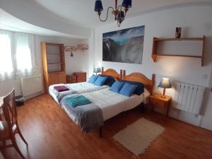 a bedroom with two beds with blue pillows at MERINDADES AMAZUL MILANO - Piso turístico - Medina de Pomar in Medina de Pomar
