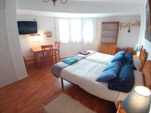 a bedroom with a large bed with blue pillows at MERINDADES AMAZUL MILANO - Piso turístico - Medina de Pomar in Medina de Pomar +52 photos