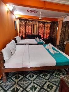 a bedroom with two beds with towels on them at Neev Beach View Goa in Anjuna
