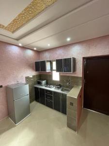 a large kitchen with a stove and a sink at holiday homes ideal for families at IGHIZINN resort in Er Rachidia