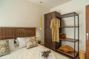a bedroom with a bed with a wooden headboard and a shelf at Samos Tropic Apartments in Ríva