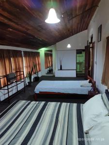 a large bedroom with two beds and a large rug at Spring Shannon Heritage in Diyatalawa