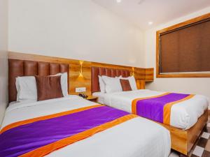 Postel nebo postele na pokoji v ubytování Hotel Era Mumbai