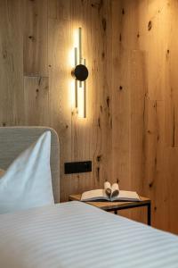 a bedroom with a bed with a book and a lamp at Chalet Samont in Laion