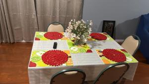 a table with a vase of flowers on it at Guest House 3 BEDROOM 2 Bathrooms 5 MINS TO EWR NEWARK AIRPORT 4 MINS TO PENN STATION in Newark