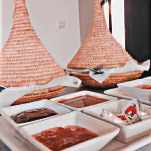a table with plates of food on a table with baskets at sidi kaouki ayt karoum in Sidi Kaouki
