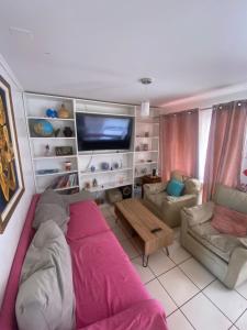 a living room with a couch and a tv at Casa en coquimbo in Coquimbo