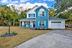 a blue house with a car garage at North Tybee Beach Home, Near the Beach, Restaurants, Shops and More! Heated Pool Access in Tybee Island