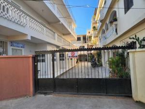 a black gate in front of a building at Residencia NILAYA in Las Terrenas