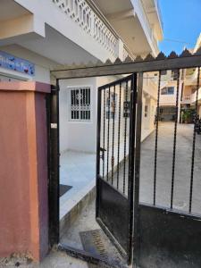 an open gate to a building with a garage at Residencia NILAYA in Las Terrenas