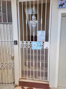 a gate in front of a house with a sign on it at Residencia NILAYA in Las Terrenas