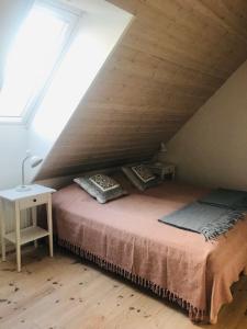 a bedroom with a bed in a attic at Arnhög Farm in Borrby