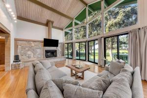 a large living room with a large couch and a fireplace at Hale Ho'omaha in Princeville