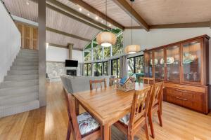 a dining room with a wooden table and chairs at Hale Ho'omaha in Princeville