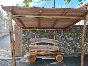 a wooden bench under a wooden structure at La Mélisse 